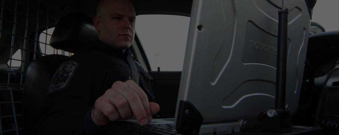 Image of officer in squad car on computer